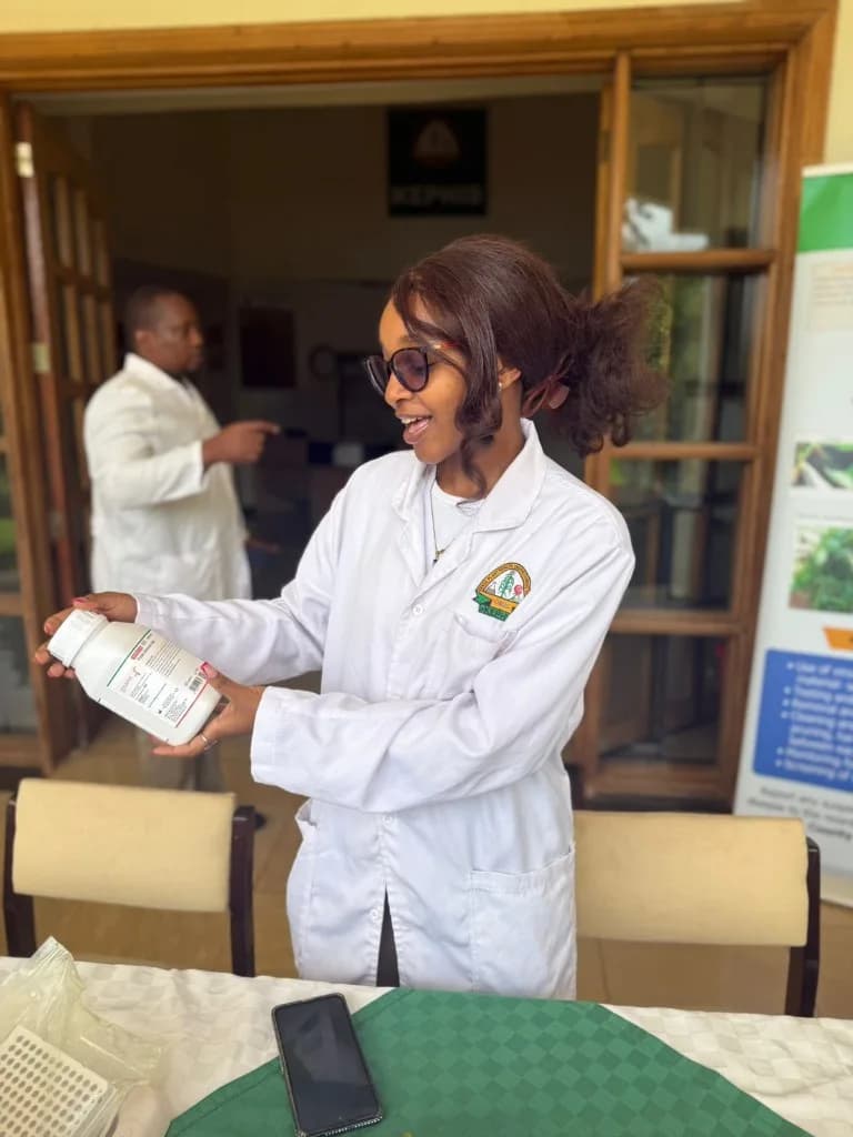 Agricultural scientist in lab coat examining a sample bottle
